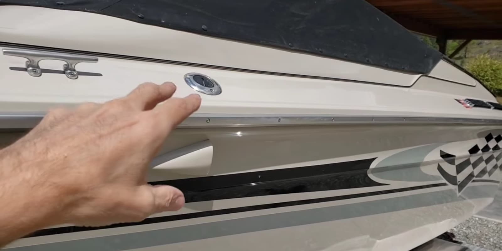 Lee's hand indicating the finished, high-gloss hull of a Sea Ray Pachanga after a T'sillan BDG application.